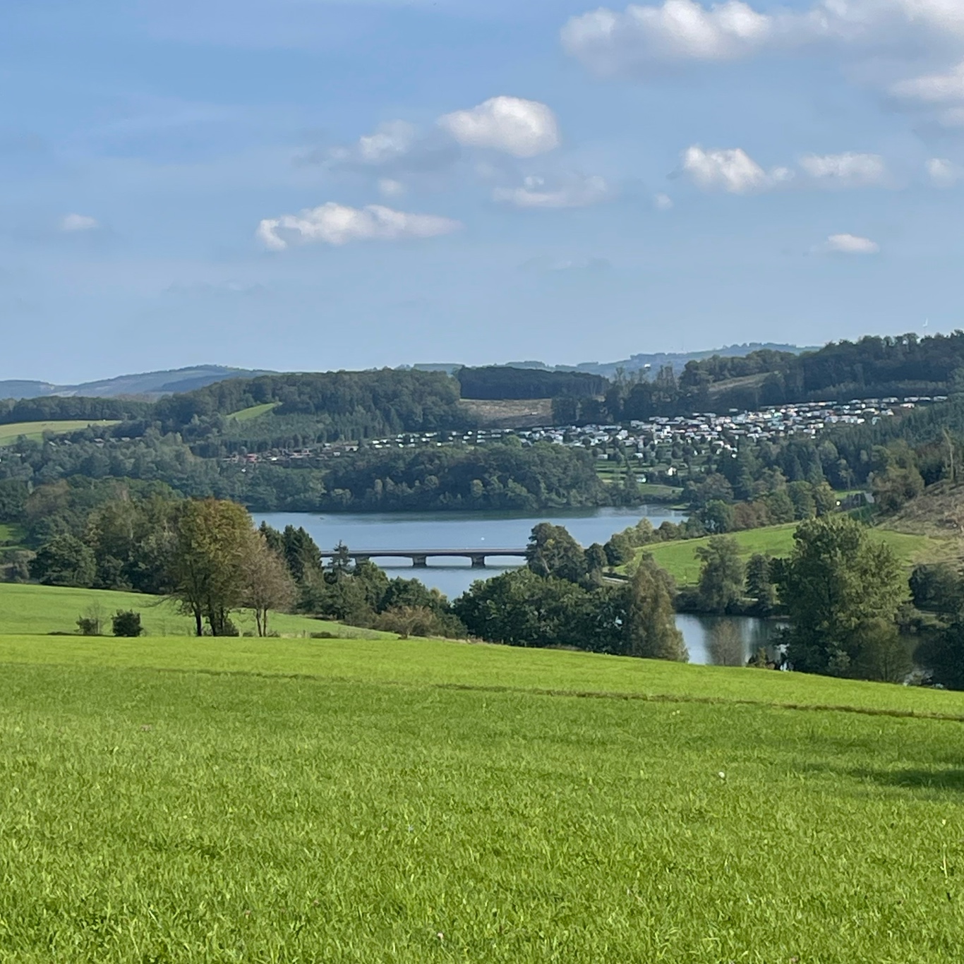 A view on the lake with a huge camping behind it